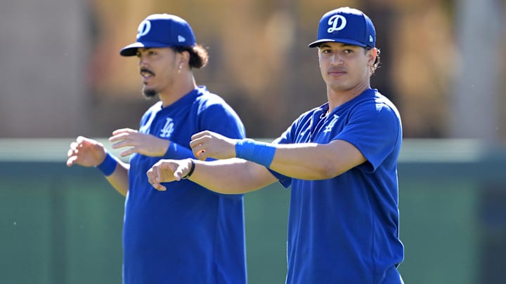 Feb 19, 2024; Glendale, AZ, USA; Los Angeles Dodgers second baseman Miguel Vargas (14) and catcher Diego Cartaya (76) stretch during spring training at Camelback Ranch. Mandatory Credit: Jayne Kamin-Oncea-Imagn Images