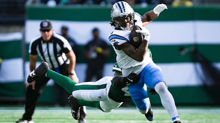 Carolina Panthers running back Rico Dowdle (5) runs the ball as New York Jets linebacker Jamien Sherwood (44) attempts a tackle during a game at MetLife Stadium, Oct 19, 2025, East Rutherford, NJ, USA.