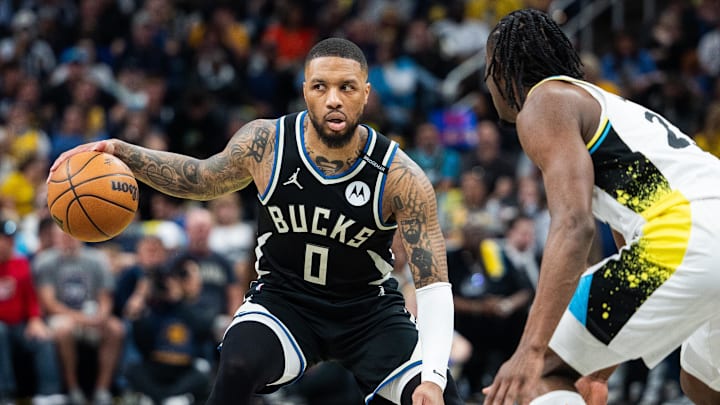 Former Milwaukee Bucks guard Damian Lillard (0) dribbles the ball while Indiana Pacers forward Aaron Nesmith (23) defends during game two of first round for the 2024 NBA Playoffs at Gainbridge Fieldhouse. Former Milwaukee Bucks guard Damian Lillard (0) dribbles the ball while Indiana Pacers forward Aaron Nesmith (23) defends during game two of first round for the 2024 NBA Playoffs at Gainbridge Fieldhouse.