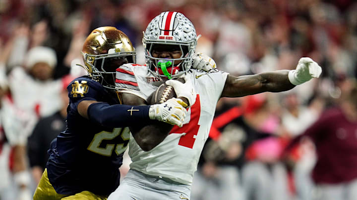 Ohio State Buckeyes wide receiver Jeremiah Smith (4) makes a catch against Notre Dame Fighting Irish cornerback Christian Gray (29) in the fourth quarter during the College Football Playoff National Championship at Mercedes-Benz Stadium in Atlanta on January 20, 2025.