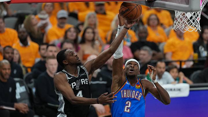 May 22, 2026; San Antonio, Texas, USA; San Antonio Spurs guard De'aaron Fox (4) shoots over Oklahoma City Thunder guard Shai Gilgeous-Alexander (2) in the second half during game three of the western conference finals for the 2026 NBA playoffs at Frost Bank Center. Mandatory Credit: Daniel Dunn-Imagn Images