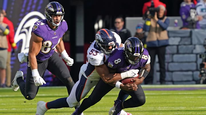 Dec 4, 2022; Baltimore, Maryland, USA; Baltimore Ravens quarterback Lamar Jackson (8) would leave the game after being sacked in the second quarter by Denver Broncos linebacker Jonathon Cooper (53) at M&T Bank Stadium. Mandatory Credit: Mitch Stringer-Imagn Images
