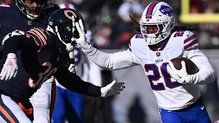 Buffalo Bills running back James Cook (28) fends off tackler Chicago Bears defensive back DeAndre Houston-Carson (36) in the first half at Soldier Field. Mandatory Credit: Jamie Sabau-Imagn Images