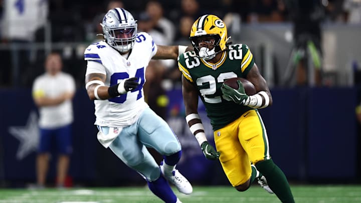 Sep 28, 2025; Arlington, Texas, USA; Green Bay Packers running back Emanuel Wilson (23) runs against Dallas Cowboys defensive end Marshawn Kneeland (94) in the first quarter at AT&T Stadium. Mandatory Credit: Kevin Jairaj-Imagn Images