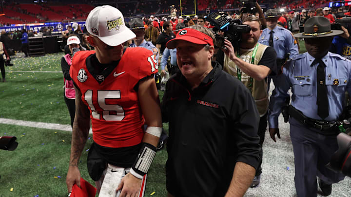 Dec 7, 2024; Atlanta, GA, USA; Georgia Bulldogs quarterback Carson Beck (15) and head coach Kirby Smart  react after defeating the Texas Longhorns in overtime in the 2024 SEC Championship game at Mercedes-Benz Stadium. Mandatory Credit: Brett Davis-Imagn Images