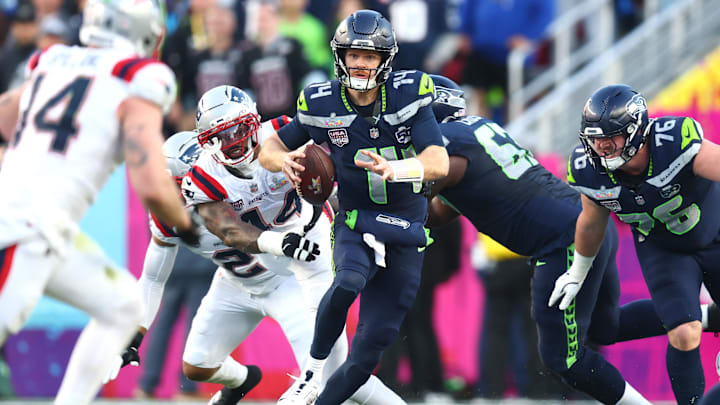 Feb 8, 2026; Santa Clara, CA, USA; Seattle Seahawks quarterback Sam Darnold (14) runs against New England Patriots linebacker K'lavon Chaisson (44) during the second quarter in Super Bowl LX at Levi's Stadium. Mandatory Credit: Mark J. Rebilas-Imagn Images