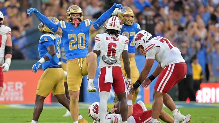 Oct 17, 2026; Pasadena, California, USA;  UCLA Bruins linebacker Scott Taylor (20) reacts after sacking Wisconsin Badgers quarterback Colton Joseph (1) in the first half at the Rose Bowl. Mandatory Credit: Jayne Kamin-Oncea-Imagn Images