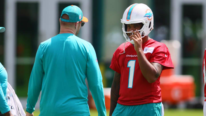 Jun 4, 2024; Miami Gardens, FL, USA; Miami Dolphins quarterback Tua Tagovailoa (1) talks to quarterback coach Darrell Bevell during mandatory minicamp at Baptist Health Training Complex. Jun 4, 2024; Miami Gardens, FL, USA; Miami Dolphins quarterback Tua Tagovailoa (1) talks to quarterback coach Darrell Bevell during mandatory minicamp at Baptist Health Training Complex.