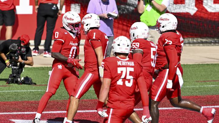 Oct 18, 2025; Houston, Texas, USA; Houston Cougars wide receiver Amare Thomas (0) celebrates with teammates after scoring a touchdown during the first quarter against the Arizona Wildcats at TDECU Stadium. Mandatory Credit: Maria Lysaker-Imagn Images 