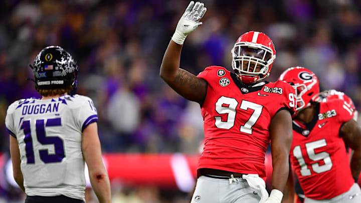 Jan 9, 2023; Inglewood, CA, USA; Georgia Bulldogs defensive lineman Warren Brinson (97) reacts next to TCU Horned Frogs quarterback Max Duggan (15) during the second half in the CFP national championship game at SoFi Stadium. Mandatory Credit: Gary A. Vasquez-Imagn Images