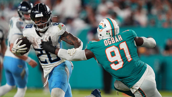 Miami Dolphins linebacker Emmanuel Ogbah (91) reaches for Tennessee Titans running back Tony Pollard (20) Miami Dolphins linebacker Emmanuel Ogbah (91) reaches for Tennessee Titans running back Tony Pollard (20)