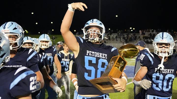 Petoskey seniors Connor Berg (58), Jace Shaw (90) and others run off with the Jaycees Traveling Trophy after earning a 42-21 win over Gaylord on Friday, Oct. 2 at Northmen Stadium in Petoskey.