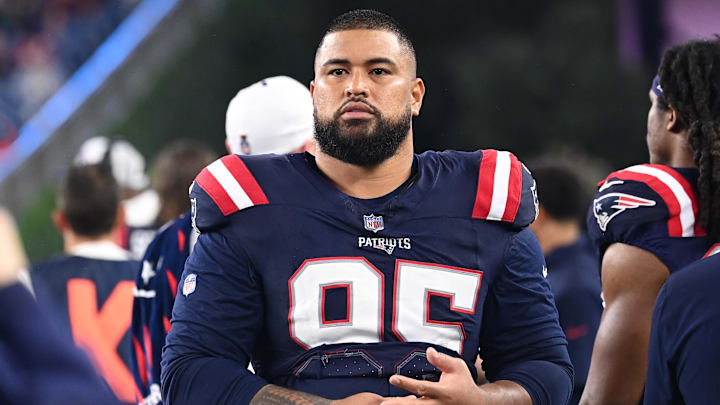 August 8, 2024; Foxborough, MA, USA;  New England Patriots defensive tackle Daniel Ekuale (95) watches from the sideline during the first half against the Carolina Panthers at Gillette Stadium. Mandatory Credit: Eric Canha-Imagn Images