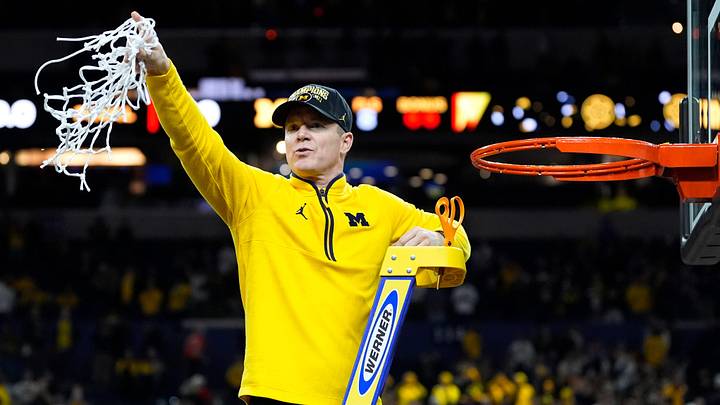 Michigan head coach Dusty May swings the net after winning the NCAA national championship against Connecticut at Lucas Oil Stadium in Indianapolis on Monday, April 6, 2026. Michigan head coach Dusty May swings the net after winning the NCAA national championship against Connecticut at Lucas Oil Stadium in Indianapolis on Monday, April 6, 2026.
