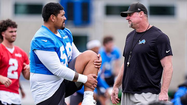 Detroit Lions offensive tackle Penei Sewell (58), left, talks to head coach Dan Campbell at practice during minicamp Detroit Lions offensive tackle Penei Sewell (58), left, talks to head coach Dan Campbell at practice during minicamp