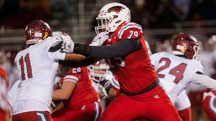 Nixa Eagles Jackson Cantwell holds back a Joplin defender during the championship game of Class 6 District 5 football at Nixa on Friday, Nov. 11, 2023.