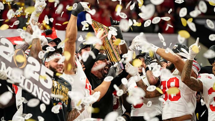 Ohio State Buckeyes head coach Ryan Day and players celebrate with the trophy following the 34-23 win over the Notre Dame Fighting Irish to win the College Football Playoff National Championship at Mercedes-Benz Stadium in Atlanta on Jan. 22, 2025. Ohio State Buckeyes head coach Ryan Day and players celebrate with the trophy following the 34-23 win over the Notre Dame Fighting Irish to win the College Football Playoff National Championship at Mercedes-Benz Stadium in Atlanta on Jan. 22, 2025.