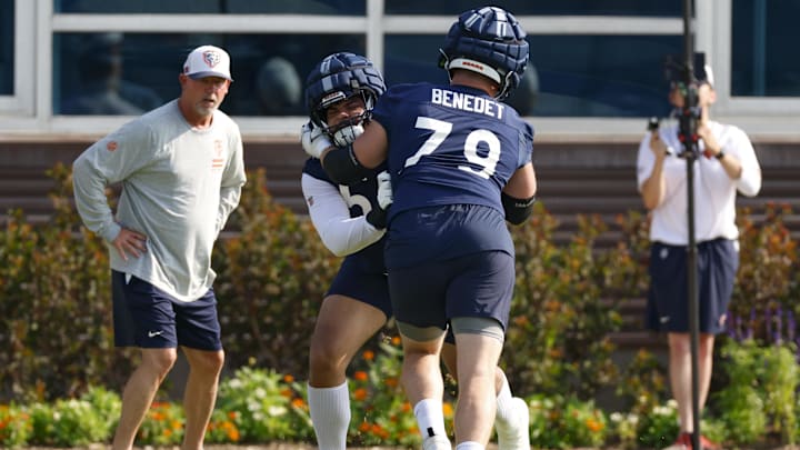 Darnell Wright and Theo Benedet work the pads during the individual session of training camp.
