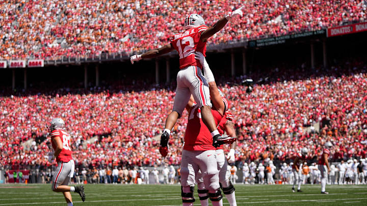 Ohio State Buckeyes running back CJ Donaldson (12) celebrates a touchdown with offensive lineman Carson Hinzman (75) during the first half of the NCAA football game against the Texas Longhorns at Ohio Stadium on Aug. 30, 2025.