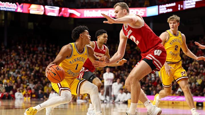 Jan 13, 2026; Minneapolis, Minnesota, USA; Minnesota Golden Gophers guard Isaac Asuma (1) dribbles the ball as Wisconsin Badgers forward Aleksas Bieliauskas (32) defends during the first half at Williams Arena.