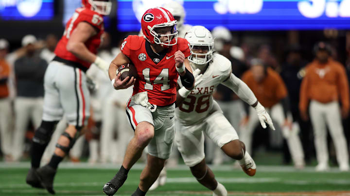 Dec 7, 2024; Atlanta, GA, USA; Georgia Bulldogs quarterback Gunner Stockton (14) rushes the ball against the Texas Longhorns during the second half in the 2024 SEC Championship game at Mercedes-Benz Stadium. Mandatory Credit: Brett Davis-Imagn Images