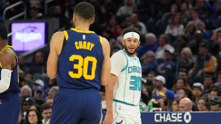 Feb 23, 2024; San Francisco, California, USA; Charlotte Hornets guard Seth Curry (right) talks with Golden State Warriors guard Stephen Curry (left) during the fourth quarter at Chase Center. Mandatory Credit: Darren Yamashita-Imagn Images