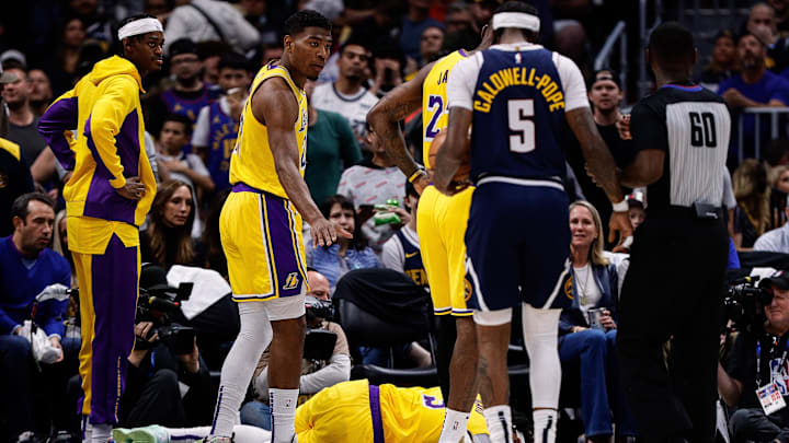 Apr 29, 2024; Denver, Colorado, USA; Los Angeles Lakers forward Anthony Davis (3) lies on the court as forward Rui Hachimura (28) and forward LeBron James (23) and forward Jarred Vanderbilt (2) look on in the third quarter against the Denver Nuggets during game five of the first round for the 2024 NBA playoffs at Ball Arena. Mandatory Credit: Isaiah J. Downing-Imagn Images