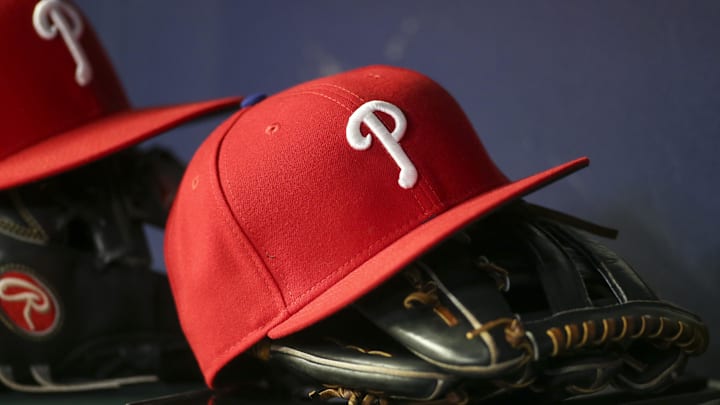 May 25, 2022; Atlanta, Georgia, USA; Detailed view of a Philadelphia Phillies hat and glove in the dugout against the Atlanta Braves in the eighth inning at Truist Park. Mandatory Credit: Brett Davis-Imagn Images