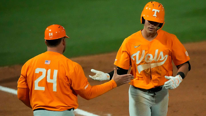 Mar 21, 2025; Tuscaloosa AL, USA; Tennessee infielder Dean Curley (1) is congratulated by the third base coach after hitting a two-run homer against Alabama in game two of the series at Sewell-Thomas Stadium.