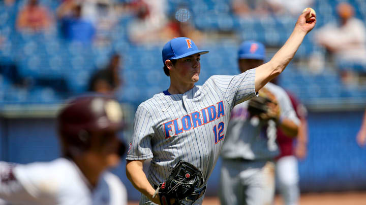 Florida pitcher Hunter Barco (12) fields a bunt and throws to first to record an out against
