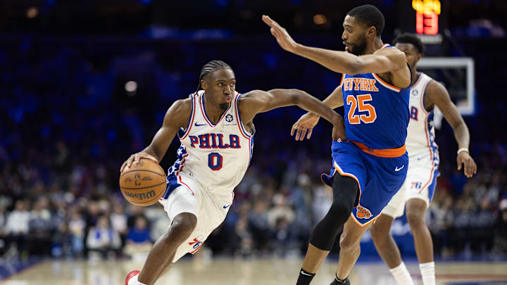 Jan 15, 2025; Philadelphia, Pennsylvania, USA; Philadelphia 76ers guard Tyrese Maxey (0) drives against New York Knicks forward Mikal Bridges (25) during the third quarter at Wells Fargo Center. Mandatory Credit: Bill Streicher-Imagn Images