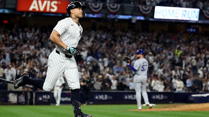 Oct 30, 2024; New York, New York, USA; New York Yankees designated hitter Giancarlo Stanton (27) reacts after hitting a home run against Los Angeles Dodgers pitcher Ryan Brasier (57) during the third inning in game five of the 2024 MLB World Series at Yankee Stadium. Oct 30, 2024; New York, New York, USA; New York Yankees designated hitter Giancarlo Stanton (27) reacts after hitting a home run against Los Angeles Dodgers pitcher Ryan Brasier (57) during the third inning in game five of the 2024 MLB World Series at Yankee Stadium.