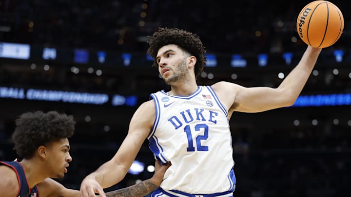 Mar 29, 2026; Washington, DC, USA; Duke Blue Devils forward Cameron Boozer (12) grabs the ball in front of UConn Huskies forward Jaylin Stewart (3) in the first half during an Elite Eight game of the East Regional of the men's 2026 NCAA Tournament at Capital One Arena. 