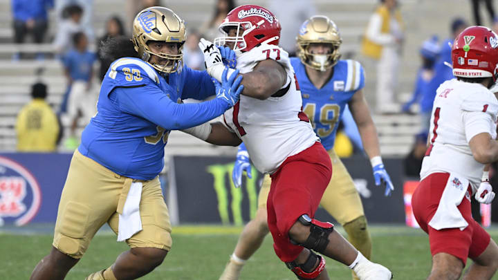 UCLA Bruins defensive lineman Jay Toia fights off a block by Fresno State Bulldogs offensive lineman Toreon Penright.