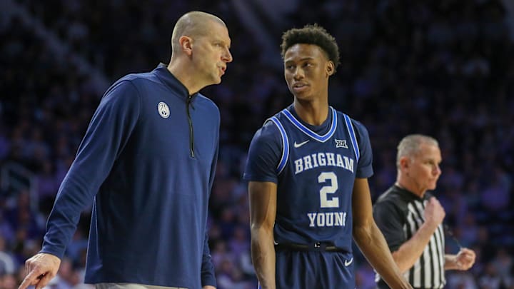 Feb 24, 2024; Manhattan, Kansas, USA; Brigham Young Cougars head coach Mark Pope talks to guard Jaxson Robinson (2) during a break in first-half action against the Kansas State Wildcats at Bramlage Coliseum. Mandatory Credit: Scott Sewell-Imagn Images
