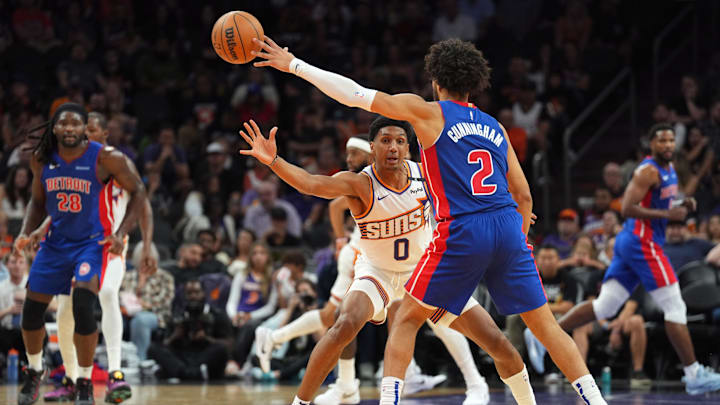 Oct 11, 2024; Phoenix, Arizona, USA; Phoenix Suns forward Ryan Dunn (0) guards Detroit Pistons guard Cade Cunningham (20: Joe Camporeale-Imagn Images