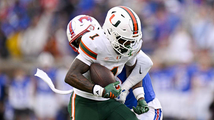 Nov 1, 2025; Dallas, Texas, USA;  Miami Hurricanes wide receiver Joshisa Trader (1) catches a pass for a touchdown against SMU Mustangs cornerback Marcellus Barnes Jr. (8)  during the first quarter at Gerald J. Ford Stadium. Mandatory Credit: Jerome Miron-Imagn Images