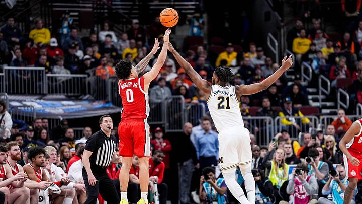 Ohio State guard John Mobley Jr. (0) shoots a 3-pointer against Michigan forward Morez Johnson Jr. (21) during the second half of Big Ten tournament quarterfinal at United Center in Chicago on Friday, March 13, 2026. Ohio State guard John Mobley Jr. (0) shoots a 3-pointer against Michigan forward Morez Johnson Jr. (21) during the second half of Big Ten tournament quarterfinal at United Center in Chicago on Friday, March 13, 2026.