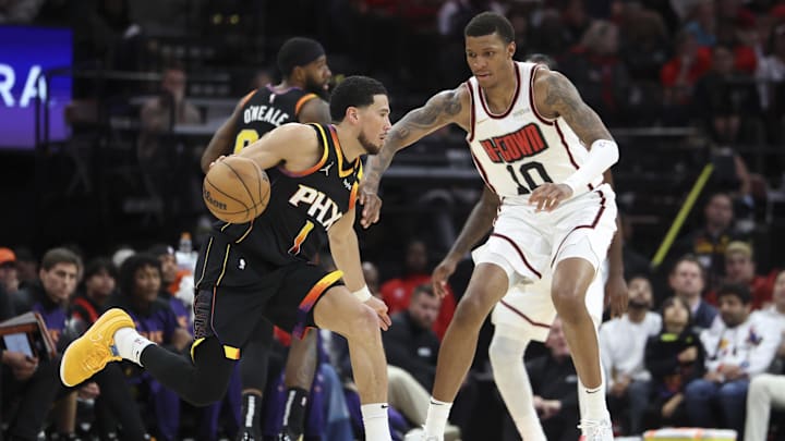 Mar 12, 2025; Houston, Texas, USA; Phoenix Suns guard Devin Booker (1) dribbles the ball as Houston Rockets forward Jabari Smith Jr. (10) defends during the fourth quarter at Toyota Center. Mandatory Credit: Troy Taormina-Imagn Images Mar 12, 2025; Houston, Texas, USA; Phoenix Suns guard Devin Booker (1) dribbles the ball as Houston Rockets forward Jabari Smith Jr. (10) defends during the fourth quarter at Toyota Center. Mandatory Credit: Troy Taormina-Imagn Images
