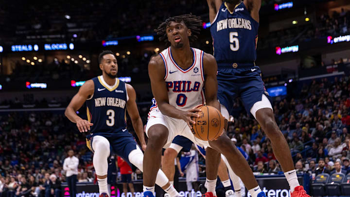 Nov 29, 2023; New Orleans, Louisiana, USA; Philadelphia 76ers guard Tyrese Maxey (0) dribbles against New Orleans Pelicans forward Herbert Jones (5) and guard CJ McCollum (3) during the first half at the Smoothie King Center. Mandatory Credit: Stephen Lew-Imagn Images