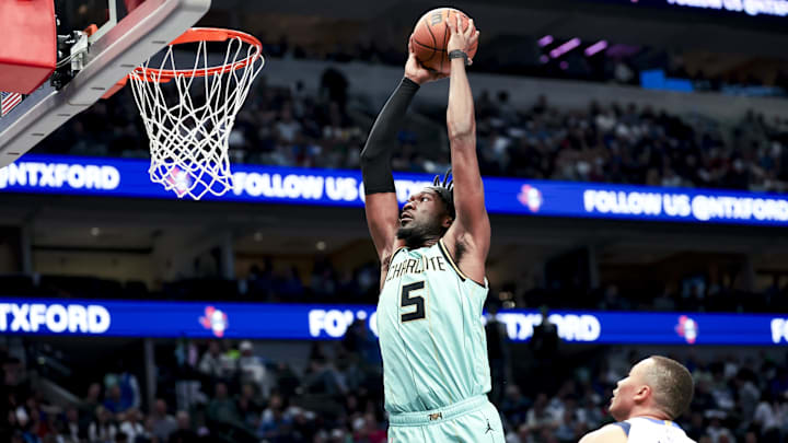 Feb 27, 2025; Dallas, Texas, USA;  Charlotte Hornets center Mark Williams (5) dunks past Dallas Mavericks guard Dante Exum (0) during the first half at American Airlines Center. Mandatory Credit: Kevin Jairaj-Imagn Images