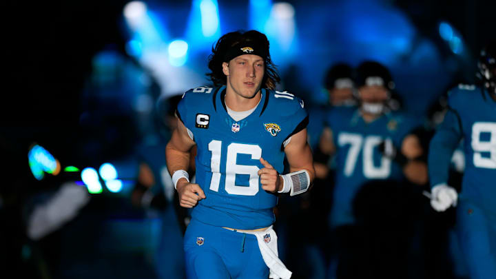 Jacksonville Jaguars quarterback Trevor Lawrence (16) runs onto the field before a regular season