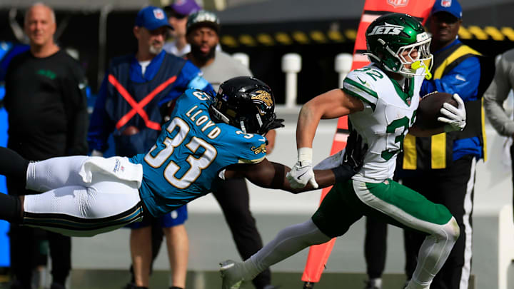 Jacksonville Jaguars linebacker Devin Lloyd (33) pressures New York Jets running back Isaiah Davis (32) out of bounds during the first quarter Sunday, Dec. 15, 2024 at EverBank Stadium in Jacksonville, Fla. [Corey Perrine/Florida Times-Union]