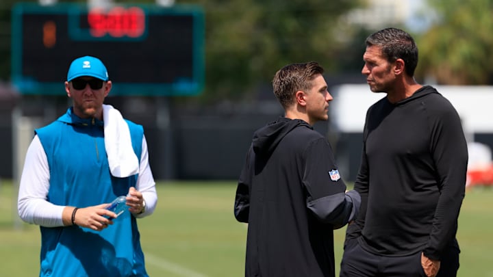 From left, Jacksonville Jaguars head coach Liam Coen, general manager James Gladstone and Tony Boselli, executive vice president of football operations, talk after an NFL training camp session at the Miller Electric Center, Thursday, Aug. 14, 2025 in Jacksonville, Fla.