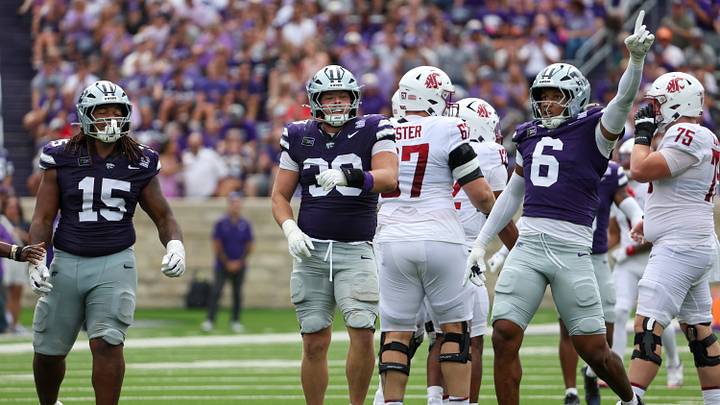 Sep 12, 2026; Manhattan, Kansas, USA; Kansas State Wildcats defensive end Travis Bates (39), linebacker Darien Whitaker (6) and defensive tackle Kamari Burns (15) celebrate a sack in the second quarter against the Washington State Cougars at Bill Snyder Family Football Stadium. Mandatory Credit: Scott Sewell-Imagn Images Sep 12, 2026; Manhattan, Kansas, USA; Kansas State Wildcats defensive end Travis Bates (39), linebacker Darien Whitaker (6) and defensive tackle Kamari Burns (15) celebrate a sack in the second quarter against the Washington State Cougars at Bill Snyder Family Football Stadium. Mandatory Credit: Scott Sewell-Imagn Images