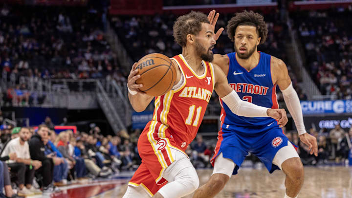 Nov 8, 2024; Detroit, Michigan, USA; Atlanta Hawks guard Trae Young (11) moves the ball up court next to Detroit Pistons guard Cade Cunningham (2) during the first half at Little Caesars Arena. Mandatory Credit: David Reginek-Imagn Images