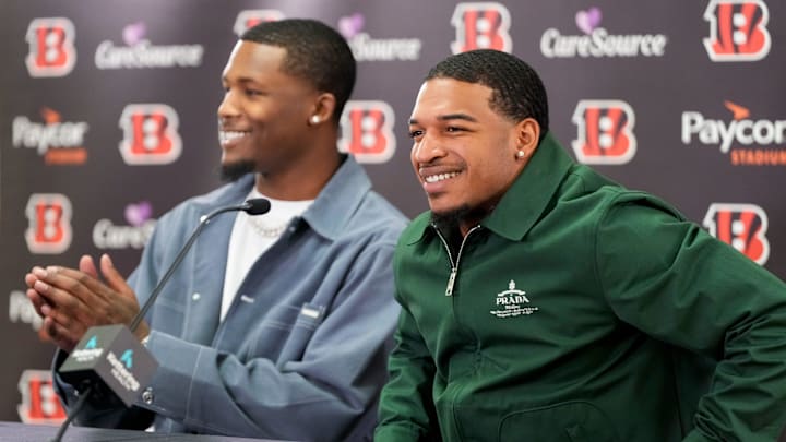Cincinnati Bengals receivers Tee Higgins (left) and Ja’marr Chase take the stage during a press conference to announce the signing of new contracts for the pair at Paycor Stadium in downtown Cincinnati on Tuesday, March 18, 2025. Chase becomes the new highest-paid non-quarterback player in the NFL.
