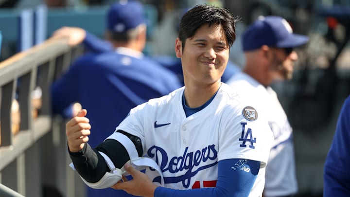 Apr 13, 2025; Los Angeles, California, USA; Los Angeles Dodgers designated hitter player Shohei Ohtani (17) prepares in the dugout before the game against the Chicago Cubs at Dodger Stadium. Mandatory Credit: Kiyoshi Mio-Imagn Images
