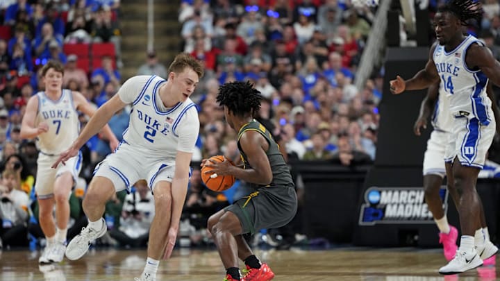 Mar 23, 2025; Raleigh, NC, USA; Baylor Bears guard Robert Wright III (1) and Duke Blue Devils forward Cooper Flagg (2) battle for the ball during the first half in the second round of the NCAA Tournament at Lenovo Center. Mandatory Credit: Bob Donnan-Imagn Images
