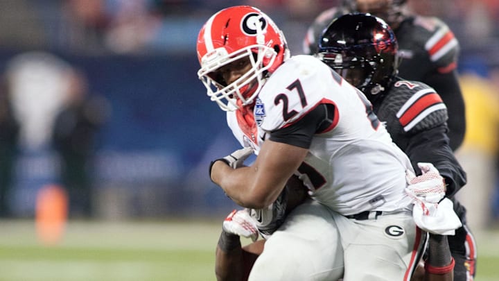 Dec 30, 2014; Charlotte, NC, USA; Georgia Bulldogs running back Nick Chubb (27) runs the ball during the second quarter against the Louisville Cardinals in the Belk Bowl held at Bank of America Stadium. Mandatory Credit: Jeremy Brevard-Imagn Images Dec 30, 2014; Charlotte, NC, USA; Georgia Bulldogs running back Nick Chubb (27) runs the ball during the second quarter against the Louisville Cardinals in the Belk Bowl held at Bank of America Stadium. Mandatory Credit: Jeremy Brevard-Imagn Images